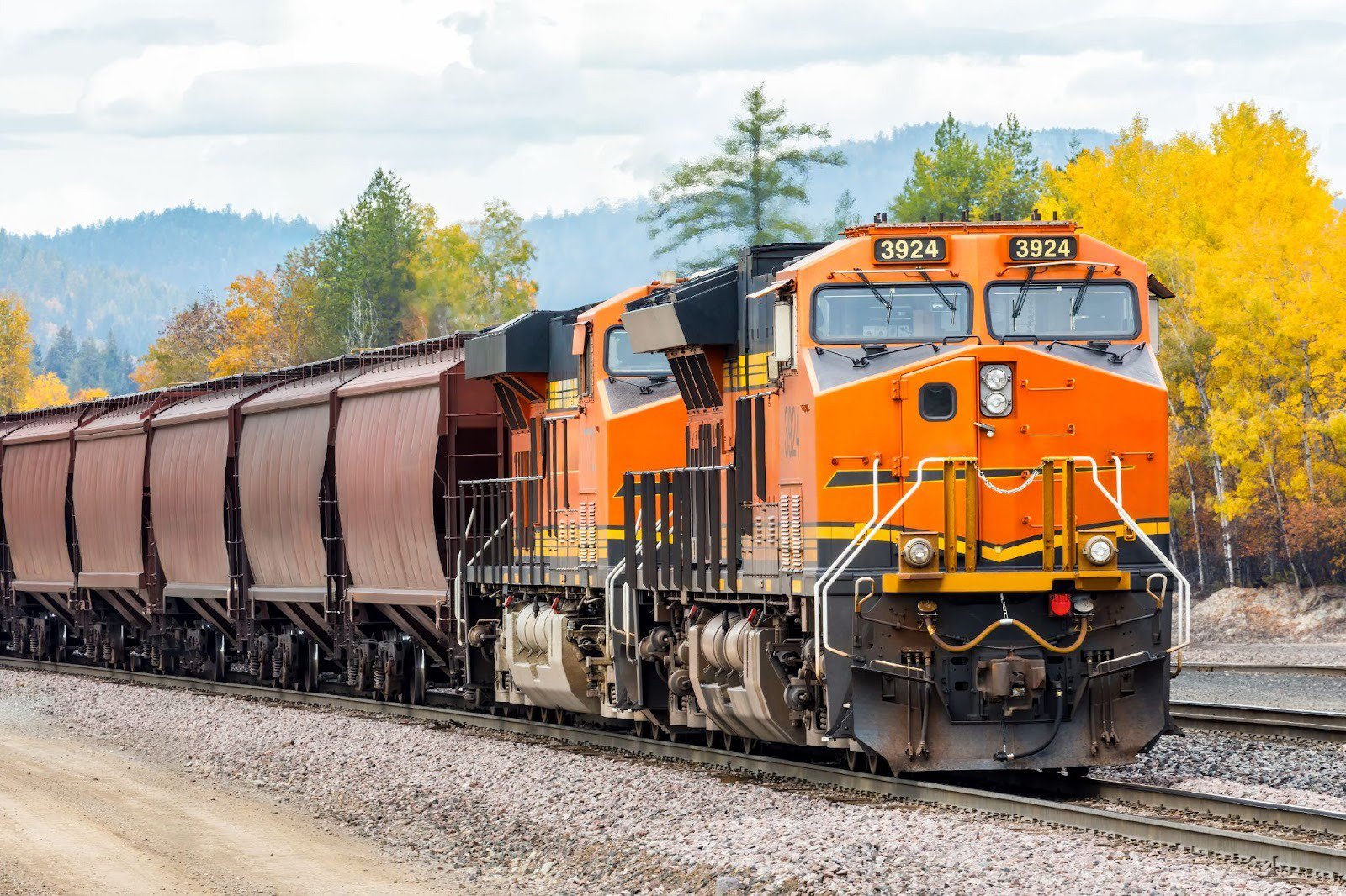 Freight train hauling cargo on a beautiful day in autumn.