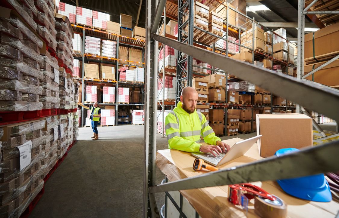 A warehouse worker fulfilling an order with a compliant labeling system