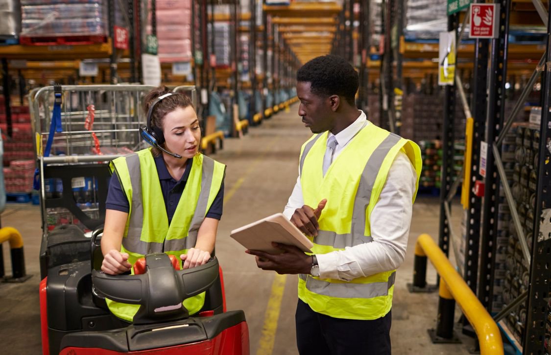 Two workers in a distribution center working with RFID tech