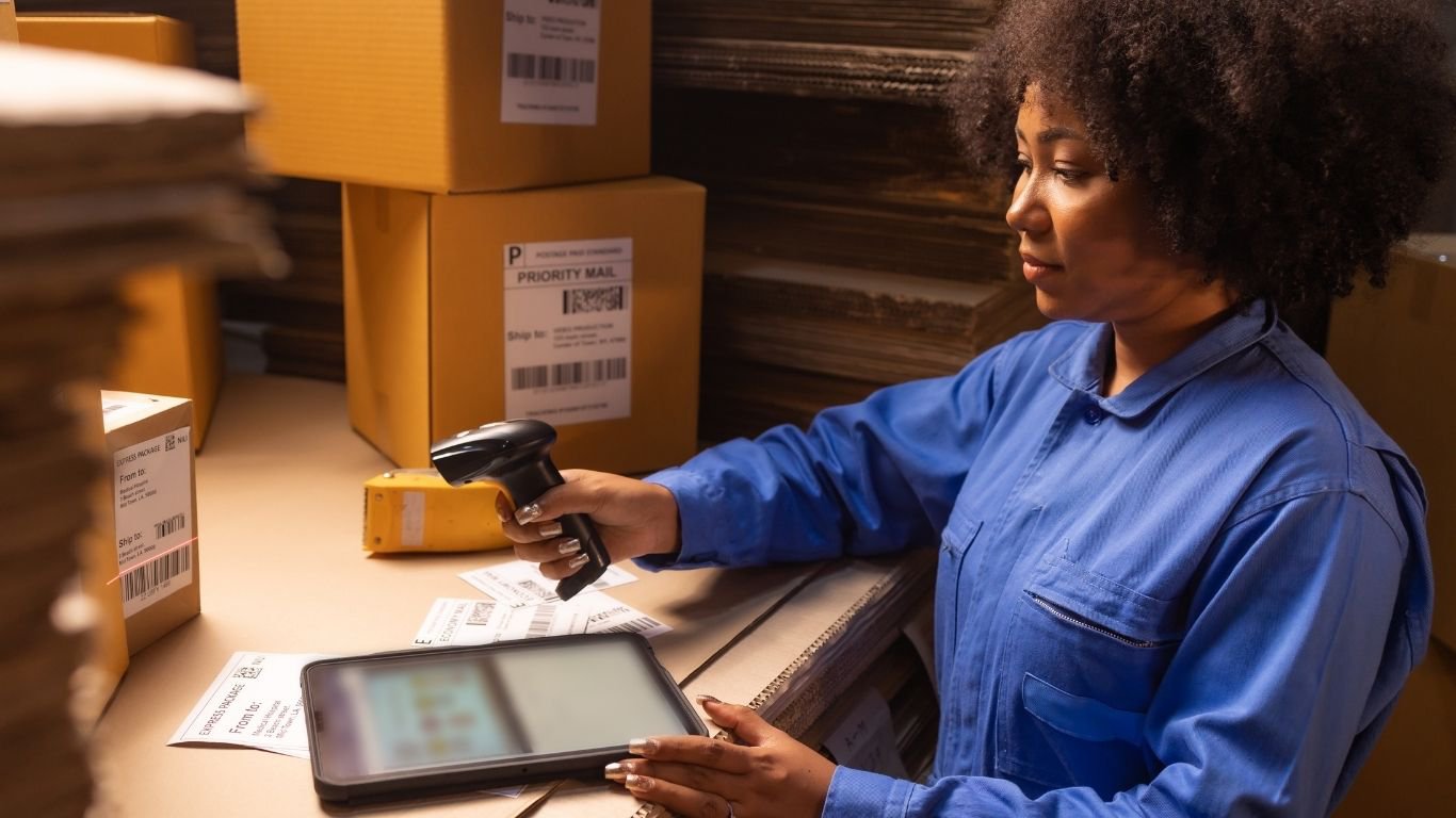 A logistics worker using a tablet scanner to track assets with an rfid heat resistant system.  2. RFID Tags Close-Up