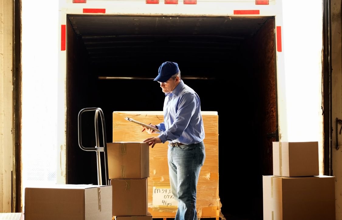 warehouse manager checking boxes to avoid mis-shipment